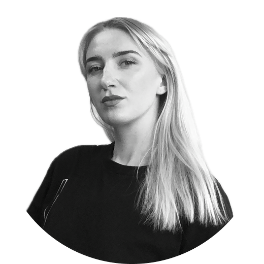 a black and white profile picture of frida wearing a black tshirt, looking into the camera